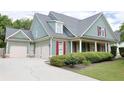 Charming two-story home with a manicured lawn, three car garage and inviting front porch with classic columns at 330 Bay Grove Rd, Loganville, GA 30052