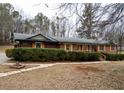 Charming brick home featuring green hedges, wooden shutters, and well-manicured yard at 3421 Fawn Trl, Marietta, GA 30066