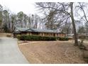 Charming brick home featuring green hedges and a long driveway at 3421 Fawn Trl, Marietta, GA 30066