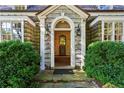 Elegant entryway with sidelights and view to the foyer, framed by lush greenery at 240 Nacoochee Nw Dr, Atlanta, GA 30305
