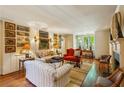 Bright living room featuring hardwood floors, built-in shelving, and ample seating at 240 Nacoochee Nw Dr, Atlanta, GA 30305