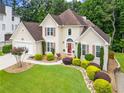 Beautiful two-story home with lush landscaping, a well-manicured lawn, and an attached two-car garage at 310 Medridge Dr, Alpharetta, GA 30022