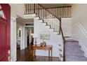 Bright foyer features hardwood floors, staircase with white railings, and elegant decor at 310 Medridge Dr, Alpharetta, GA 30022
