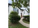 Lovely home exterior with a beautiful wood door and lush landscaping in the front yard at 1340 Stoneleigh Way, Stone Mountain, GA 30088