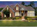 Charming brick home featuring a well-manicured lawn and lush landscaping at 1487 Monarch Ct, Marietta, GA 30062
