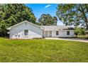 Traditional one-story home boasts a white exterior, an attached garage, and a green lawn at 1698 Brandy Woods Se Trl, Conyers, GA 30013