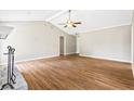 Open living area with vaulted ceiling, wood flooring, and plenty of natural light at 1698 Brandy Woods Se Trl, Conyers, GA 30013