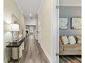 Inviting hallway with modern floors and a view into the living room at 3735 Hazel Ave, Cumming, GA 30040