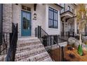 Elegant brick townhome featuring a striking blue door, complemented by black accents at 550 Fisher Dr # 47, Alpharetta, GA 30009