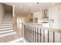 Open-concept kitchen featuring a large island and hardwood floors at 550 Fisher Dr # 47, Alpharetta, GA 30009