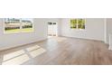 Living room with hardwood floors, natural light and sliding glass door at 2849 Bullfrog Ln # 173, Gainesville, GA 30115