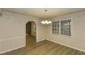 Dining room with laminate flooring, chair rail, and windows for natural light at 4631 Ben Hill Rd, Douglasville, GA 30134