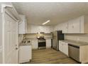 Kitchen featuring stainless steel appliances, granite countertops, and white cabinetry at 4631 Ben Hill Rd, Douglasville, GA 30134