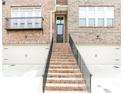 Beautiful townhome exterior with brick stairs leading to the front door and one car garage at 2145 Coventry Dr, Brookhaven, GA 30319