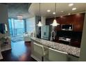 Modern kitchen with granite countertops, stainless steel appliances, and bar stool seating at 400 W Peachtree Nw St # 3412, Atlanta, GA 30308