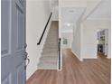 Bright entryway with hardwood floors and staircase leading to the upper level at 5891 Buckner Creek Dr, Mableton, GA 30126