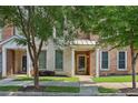 Inviting brick townhouse with manicured lawn, shaded by mature trees at 761 Liberty Commons Nw Dr, Atlanta, GA 30314