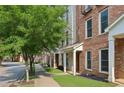 Charming brick townhouse with landscaped yard and sidewalk entrance at 761 Liberty Commons Nw Dr, Atlanta, GA 30314