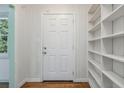 Bright entryway featuring white wood paneling, hardwood floors, and custom built-in shelving at 804 Brookdale Sw Dr, Atlanta, GA 30315