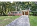 Traditional brick home with a covered carport and a sprawling green lawn at 804 Brookdale Sw Dr, Atlanta, GA 30315