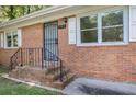 Inviting front entrance with decorative wrought iron security door and classic brick stairs at 804 Brookdale Sw Dr, Atlanta, GA 30315