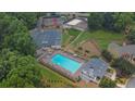 Aerial view of community pool, tennis courts, playground, parking and landscaping at 1010 San Marcos Cv, Lawrenceville, GA 30043