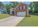 Charming two-story home with brick and siding, well-manicured lawn, and a two-car garage at 1010 San Marcos Cv, Lawrenceville, GA 30043
