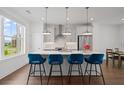 Bright kitchen features a quartz island, stainless appliances, and stylish seating at 114 Brackley Dr, Cumming, GA 30040