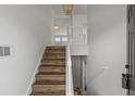 Bright entryway showcasing a staircase with wooden treads and white railing, leading to the upper level at 1910 Towne Park Dr, Mcdonough, GA 30252