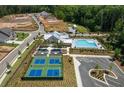 A birds eye view of the community amenities including a pool, tennis courts, clubhouse, and ample parking at 5340 Memento Trace, Cumming, GA 30040