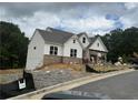 New construction with white siding, brick accents, and an attached two-car garage at 202 Willow St, Canton, GA 30114