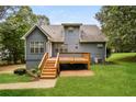 Enjoy outdoor living with a spacious wooden deck and landscaped backyard, perfect for entertaining or relaxing at 4150 Sterling Pointe Dr, Douglasville, GA 30135