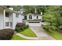 View of the home's exterior showing a well-maintained lawn and attached garage with a bonus room above at 837 Pine Ridge Dr, Lawrenceville, GA 30043