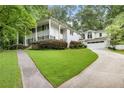 Traditional white two-story home with black shutters, a front porch, and a manicured lawn at 837 Pine Ridge Dr, Lawrenceville, GA 30043