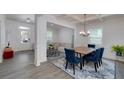 Elegant dining room featuring hardwood floors, coffered ceilings, modern chandelier, and open floor plan at 9117 Hanover St, Lithia Springs, GA 30122