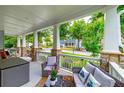 Inviting front porch with comfortable seating, stone pillars, and a view of the neighborhood at 9117 Hanover St, Lithia Springs, GA 30122