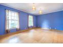 Bright, spacious bedroom with beautiful hardwood floors, blue walls, and ample natural light at 1236 S Shadygrove Ct, Stone Mountain, GA 30083