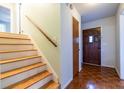 Inviting entryway features hardwood floors, stairs with wooden railing, and a solid wood door at 1236 S Shadygrove Ct, Stone Mountain, GA 30083
