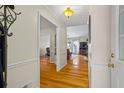 View of foyer featuring hardwood floors leading to an open living area with natural light and neutral walls at 820 Airline Rd, Mcdonough, GA 30252