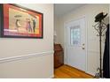 Foyer featuring a coat rack, cabinet, and framed art, complemented by hardwood floors at 820 Airline Rd, Mcdonough, GA 30252