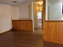 Image shows a living room with hardwood floors and wood paneling half-way up the wall at 1455 Stone Mill Trce, Stone Mountain, GA 30083