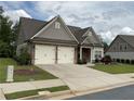 Charming home features a two-car garage, brick accents, and well-maintained landscaping at 1790 Nestledown Dr, Cumming, GA 30040