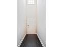 Bright foyer with dark hardwood floors leading to a white paneled door at 1505 Slopeside Loop, Smyrna, GA 30082