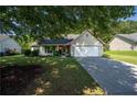 Well-maintained single-Gathering home with lovely landscaping and a charming front porch area at 5832 Sycamore Ridge Dr, Sugar Hill, GA 30518