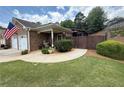 Charming brick home with a two-car garage, tidy landscaping, and welcoming curb appeal at 112 Countryside Ct, Woodstock, GA 30189