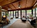 Inviting sun room with wood ceilings, ceiling fans, comfortable seating, and lots of natural light at 112 Countryside Ct, Woodstock, GA 30189