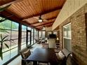 Bright sunroom with wood ceilings, ceiling fans, and views of the outdoors at 112 Countryside Ct, Woodstock, GA 30189