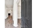 Inviting entryway featuring hardwood floors and an open view to a dining area with a fireplace at 6625 Eagle Pt, Suwanee, GA 30024