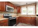 Well-equipped kitchen featuring stainless steel appliances, granite countertops, and tile backsplash at 1305 Clay Sw Rd, Mableton, GA 30126
