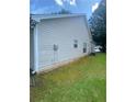Exterior of a tan home featuring a grassy yard and well-maintained siding at 2703 Hillvale Cove Dr, Lithonia, GA 30058